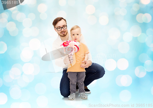 Image of happy father and son with bunch of flowers