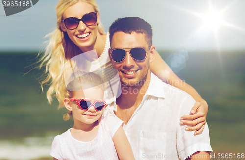 Image of happy family in sunglasses on summer beach