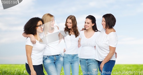 Image of group of happy different women in white t-shirts