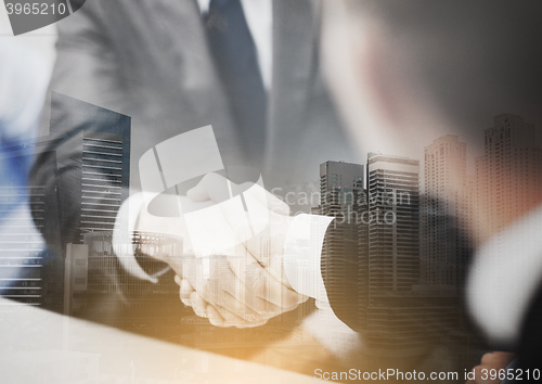 Image of two businessmen shaking hands in office