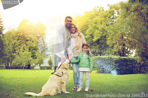 Image of happy family with labrador retriever dog in park