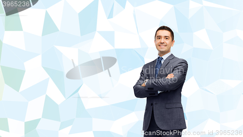 Image of smiling businessman over blue low poly texture