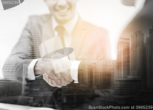 Image of two businessmen shaking hands in office