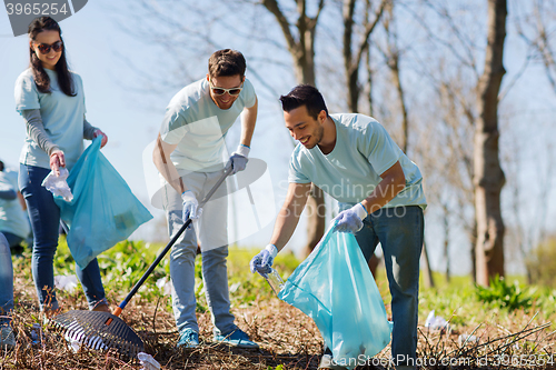 Image of volunteers with garbage bags cleaning park area