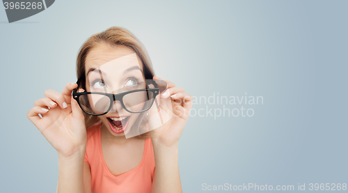 Image of happy young woman or teenage girl in eyeglasses