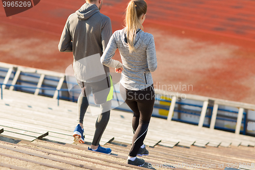 Image of couple running downstairs on stadium