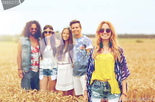 Image of smiling young hippie friends on cereal field