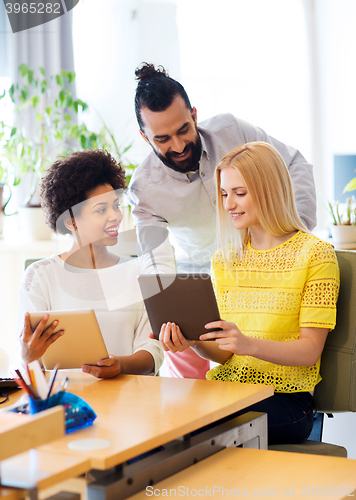 Image of happy creative team with tablet pc in office