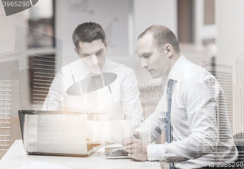 Image of two businessmen having discussion in office