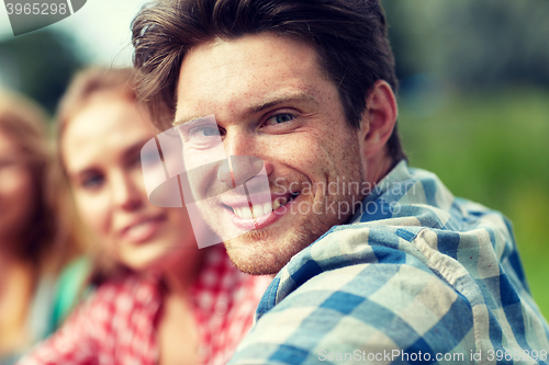 Image of group of smiling friends outdoors