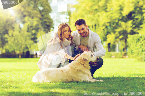 Image of happy couple with labrador dog walking in city