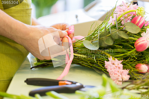 Image of close up of florist man with bunch at flower shop