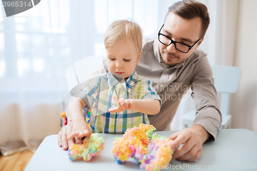 Image of father and son playing with ball clay at home