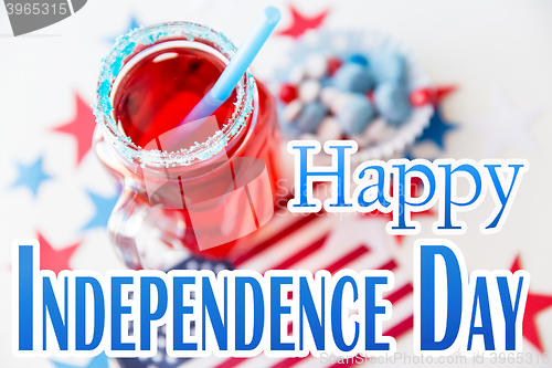 Image of juice glass and american flag on independence day