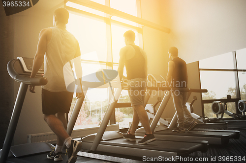 Image of men exercising on treadmill in gym