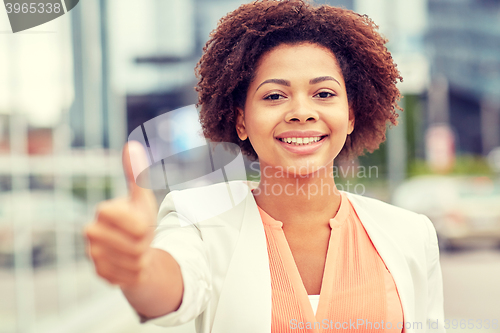 Image of happy young african american businesswoman in city