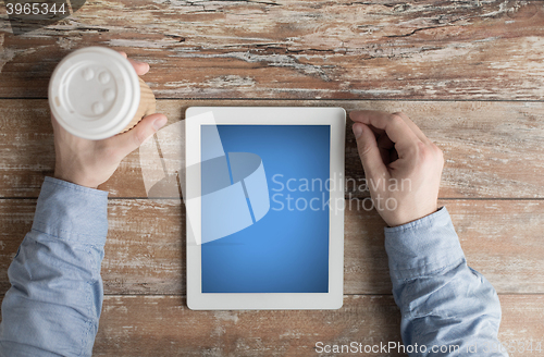 Image of close up of male hands with tablet pc and coffee