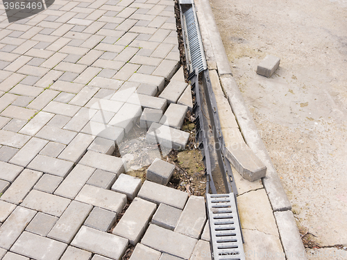 Image of The destruction of the pedestrian walkway of paving with drainage and concrete road