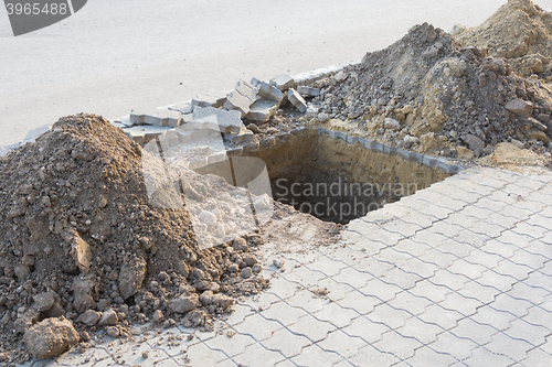 Image of Dug a pit for planting trees on the pavement of paving slabs
