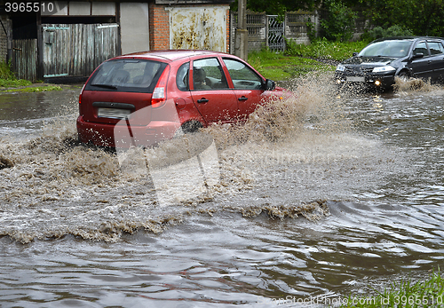 Image of Car rides in heavy rain on a flooded road