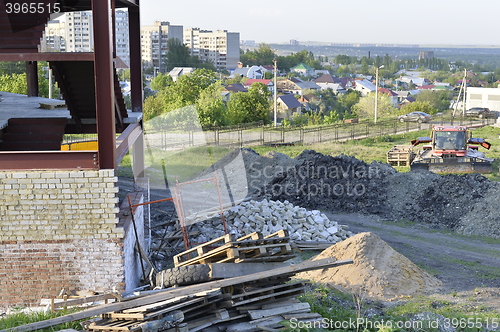 Image of Construction materials and waste on the background of building under construction