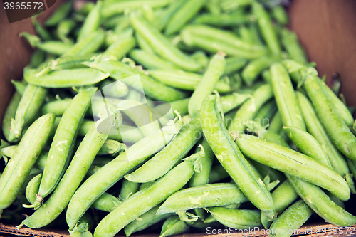 Image of close up of green peas in box at street market