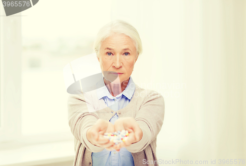 Image of senior woman with medicine at home