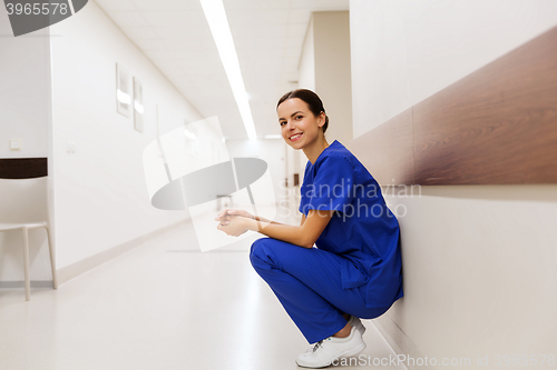 Image of happy doctor or nurse at hospital corridor