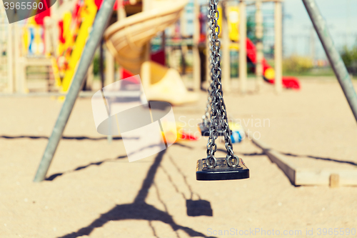 Image of close up of swing on playground outdoors