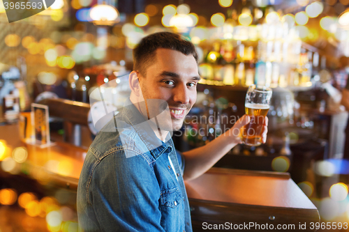 Image of happy man drinking beer at bar or pub