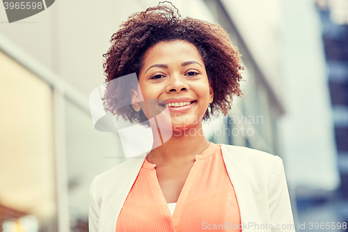 Image of happy young african american businesswoman in city