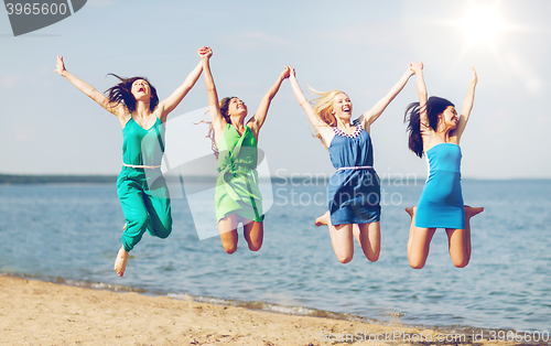 Image of girls jumping on the beach