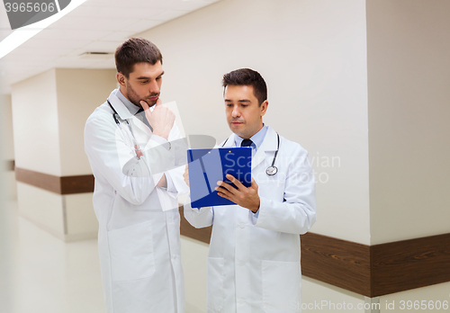 Image of two male doctors with clipboard at hospital