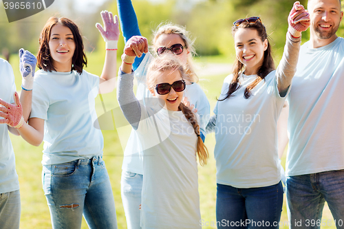 Image of group of volunteers celebrating success in park