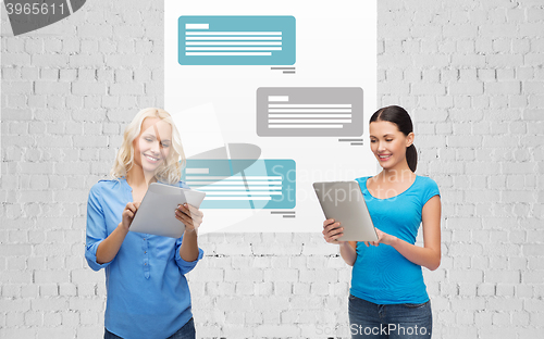 Image of happy women with tablet pc chatting in messenger