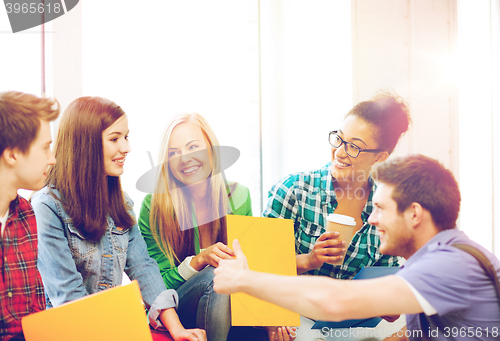 Image of students communicating and laughing at school