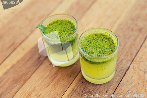 Image of glasses of fresh juice or cocktail on beach