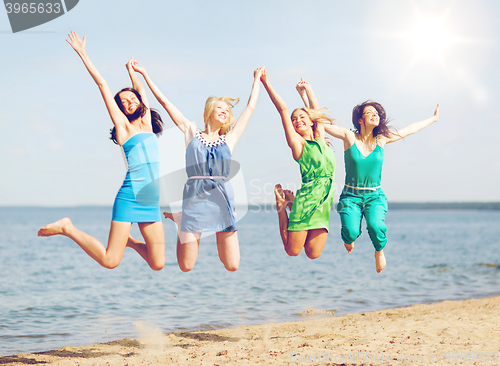 Image of girls jumping on the beach