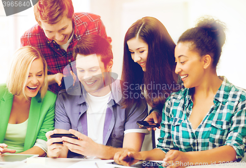 Image of students looking at smartphone at school