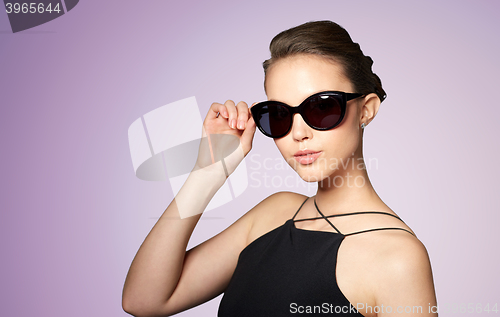 Image of beautiful young woman in elegant black sunglasses