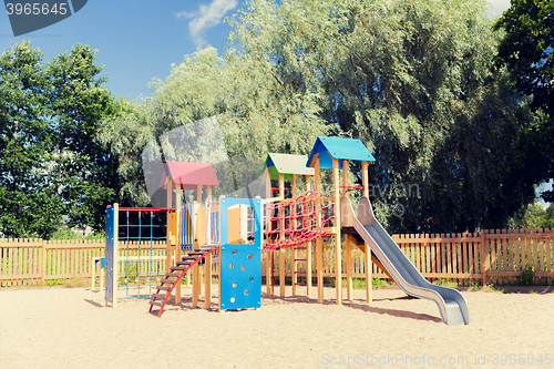 Image of climbing frame with slide on playground at summer