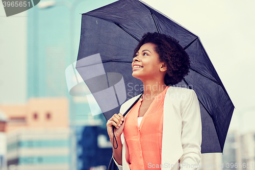 Image of happy african american businesswoman with umbrella