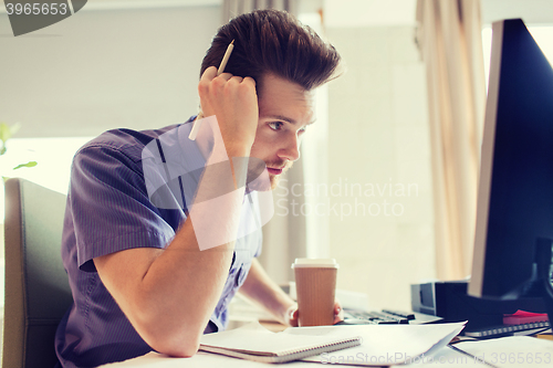 Image of creative male office worker with coffee thinking