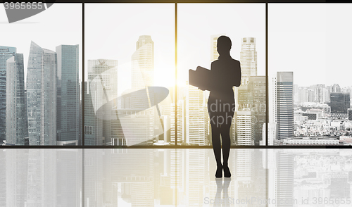 Image of silhouette of business woman with folders