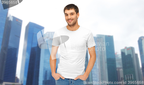 Image of man in blank white t-shirt over singapore city