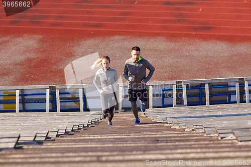 Image of couple running upstairs on stadium