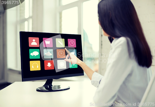 Image of close up of woman with apps on computer in office
