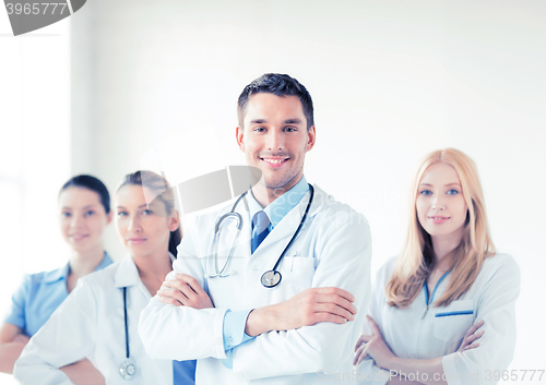 Image of male doctor in front of medical group