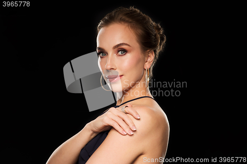 Image of beautiful woman in black wearing diamond jewelry