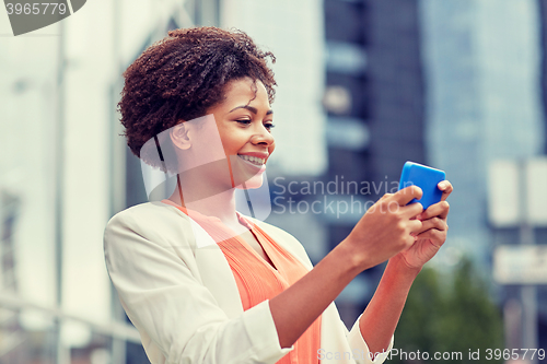 Image of happy african businesswoman with smartphone